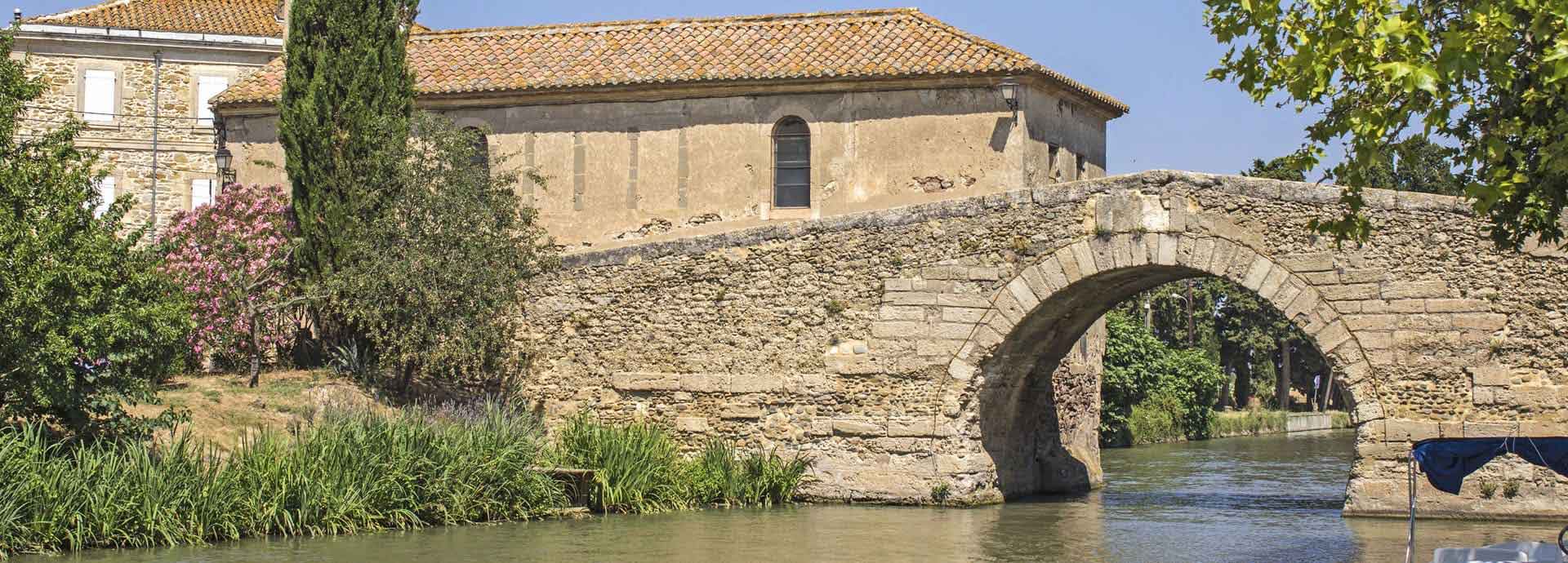 The Canal du Midi and Pont Neuf du Somail, located in the Aude Department